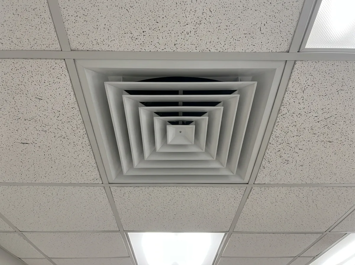 Commercial ceiling diffuser, dust streaks on the tile beside the cleared diffuser after cleaning