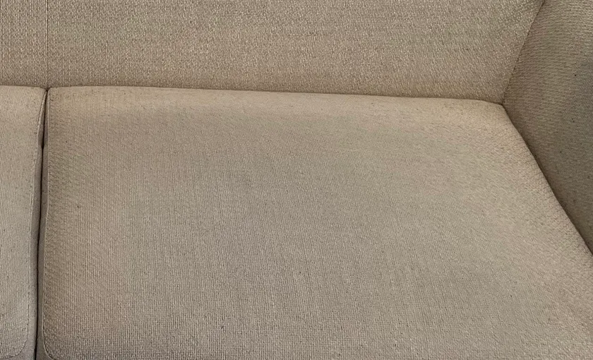 Sofa cushion, a dark stain beside the cleaned cushion after cleaning