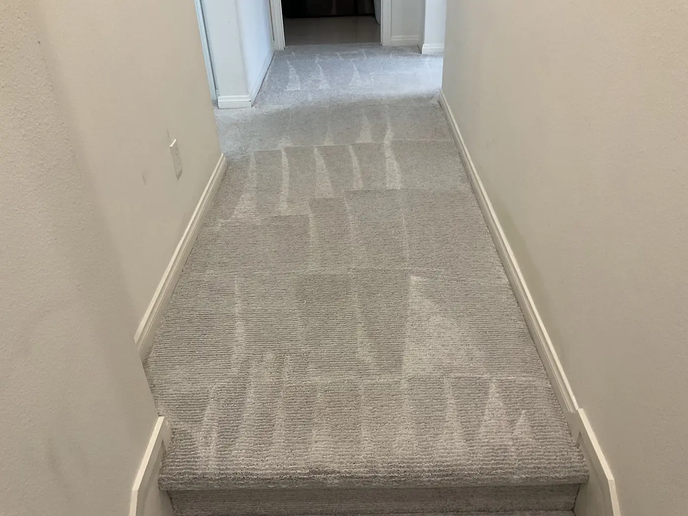 Hallway carpet, soiled lane beside the cleaned hallway after cleaning