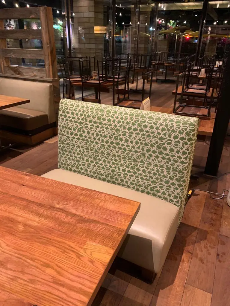 Restaurant booth seat, soiled fabric beside the cleaned seat after cleaning