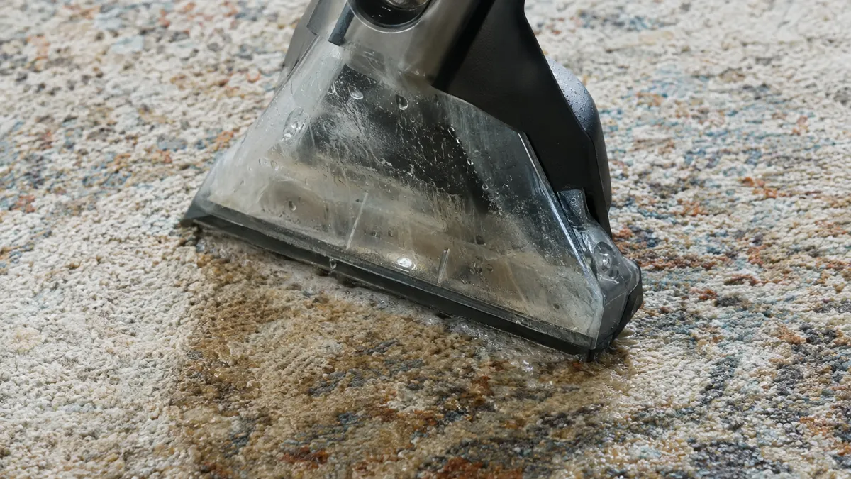 Area rug washed and rinsed on a flat table in a cleaning plant