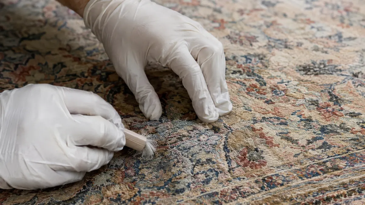 Technician cleaning a wool carpet with low agitation