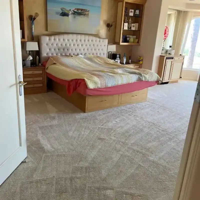 Cleaned carpet in a bedroom with a bed and nightstands