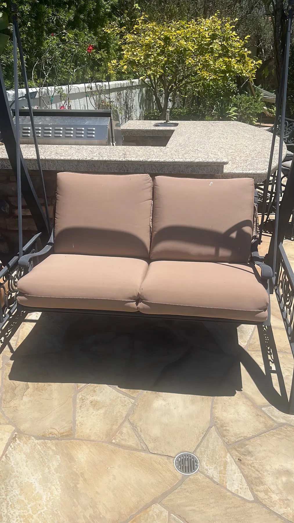 Tan outdoor cushions on a patio swing