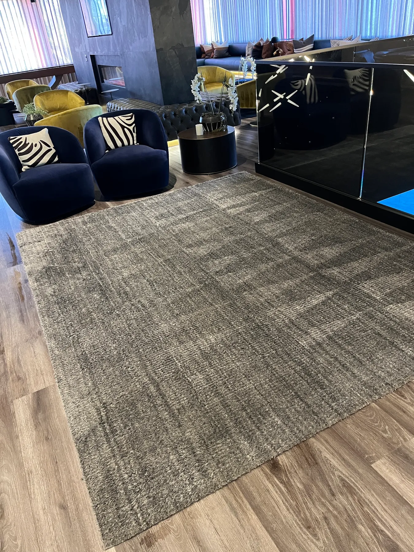 Gray area rug on a wood floor in a living room