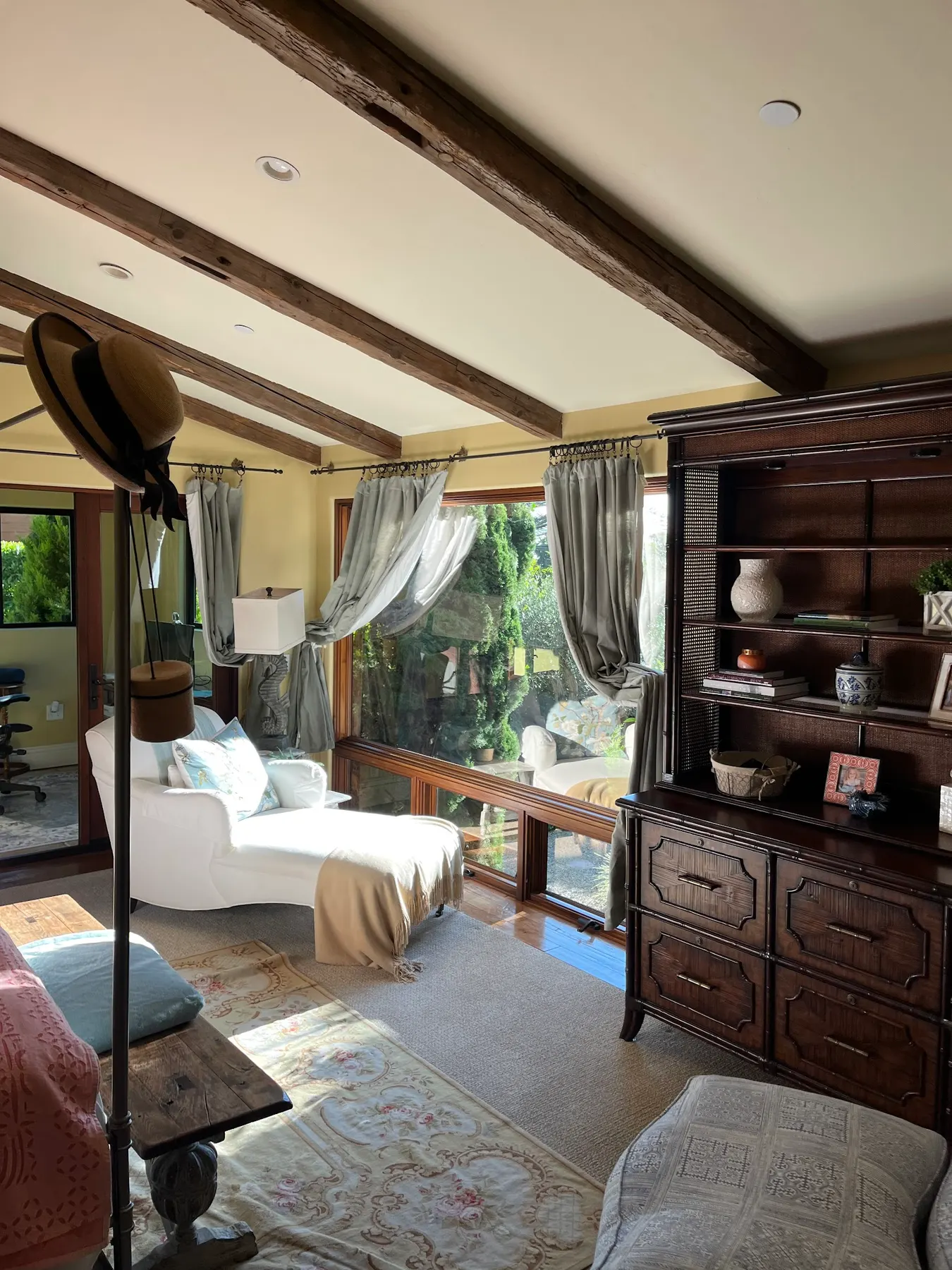 Sheer curtains along a sunroom window