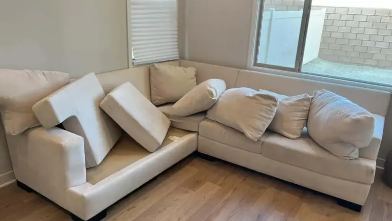 Sectional with cushions pulled for upholstery cleaning