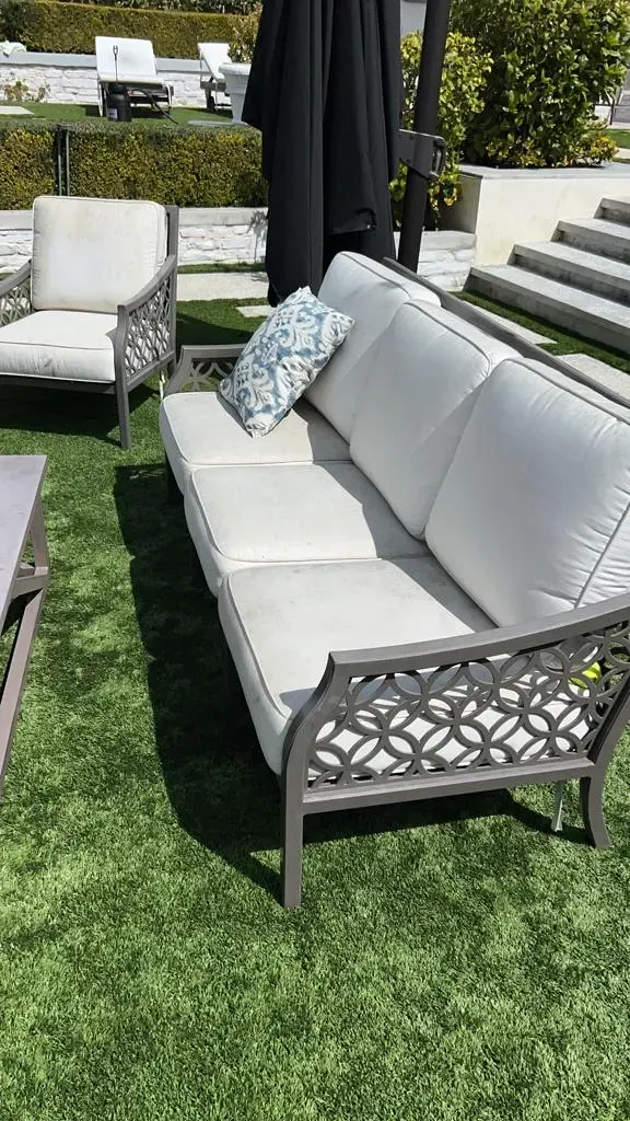 Outdoor sofa cushions cleaned on a patio