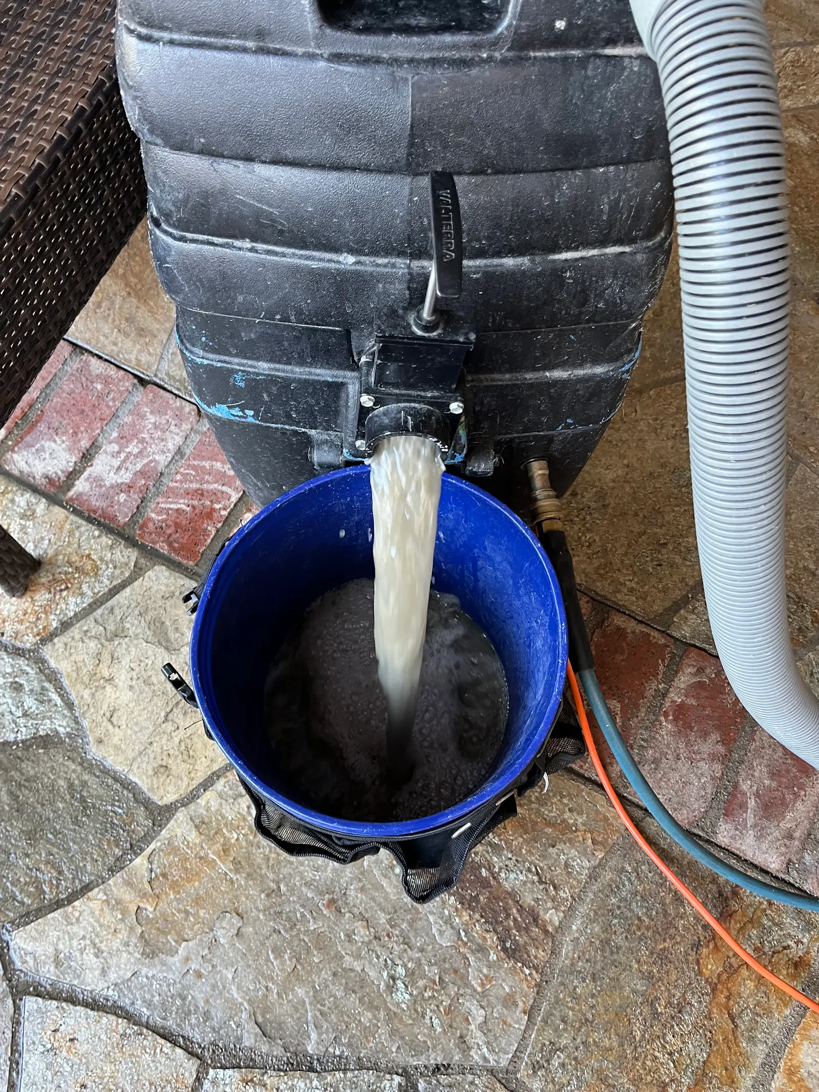 Dirty water pumped into a bucket