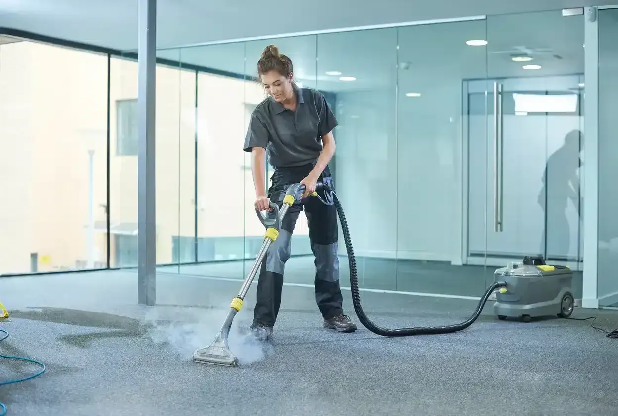 Technician treating a carpet stain with professional tools