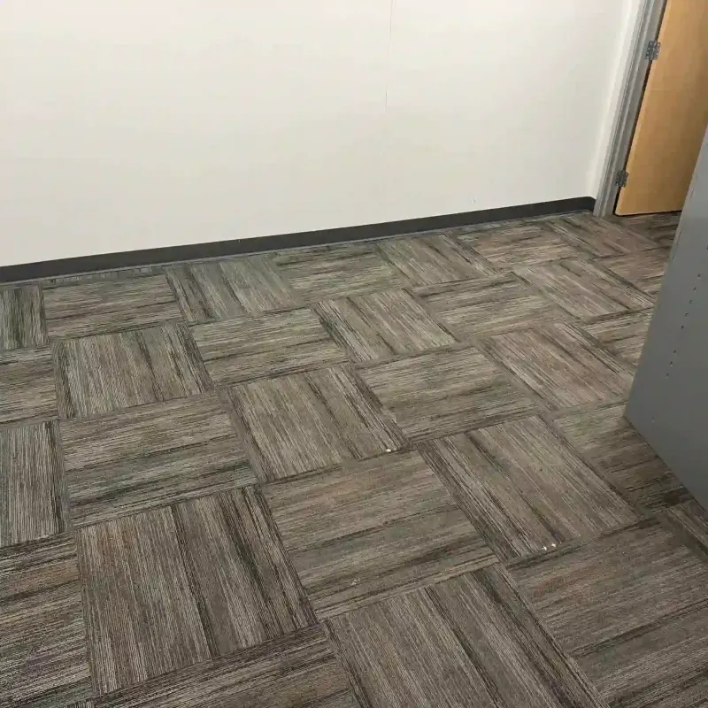 Office carpet tiles with a wood-like pattern.