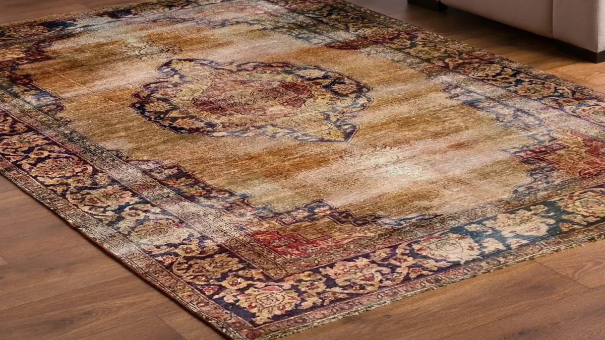 A detailed oriental rug with intricate patterns lies on a polished wooden floor.