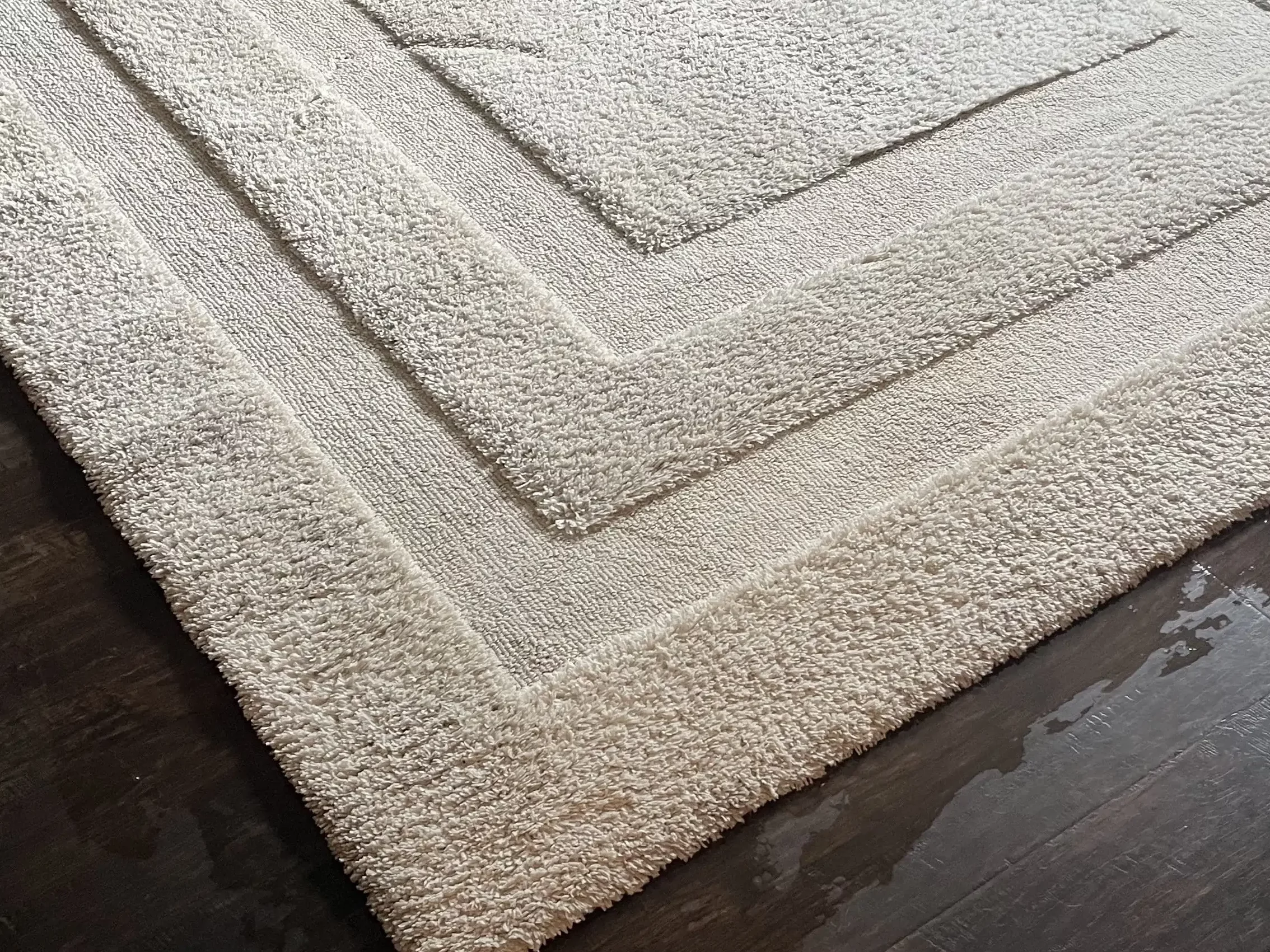 a white rug on a wood floor